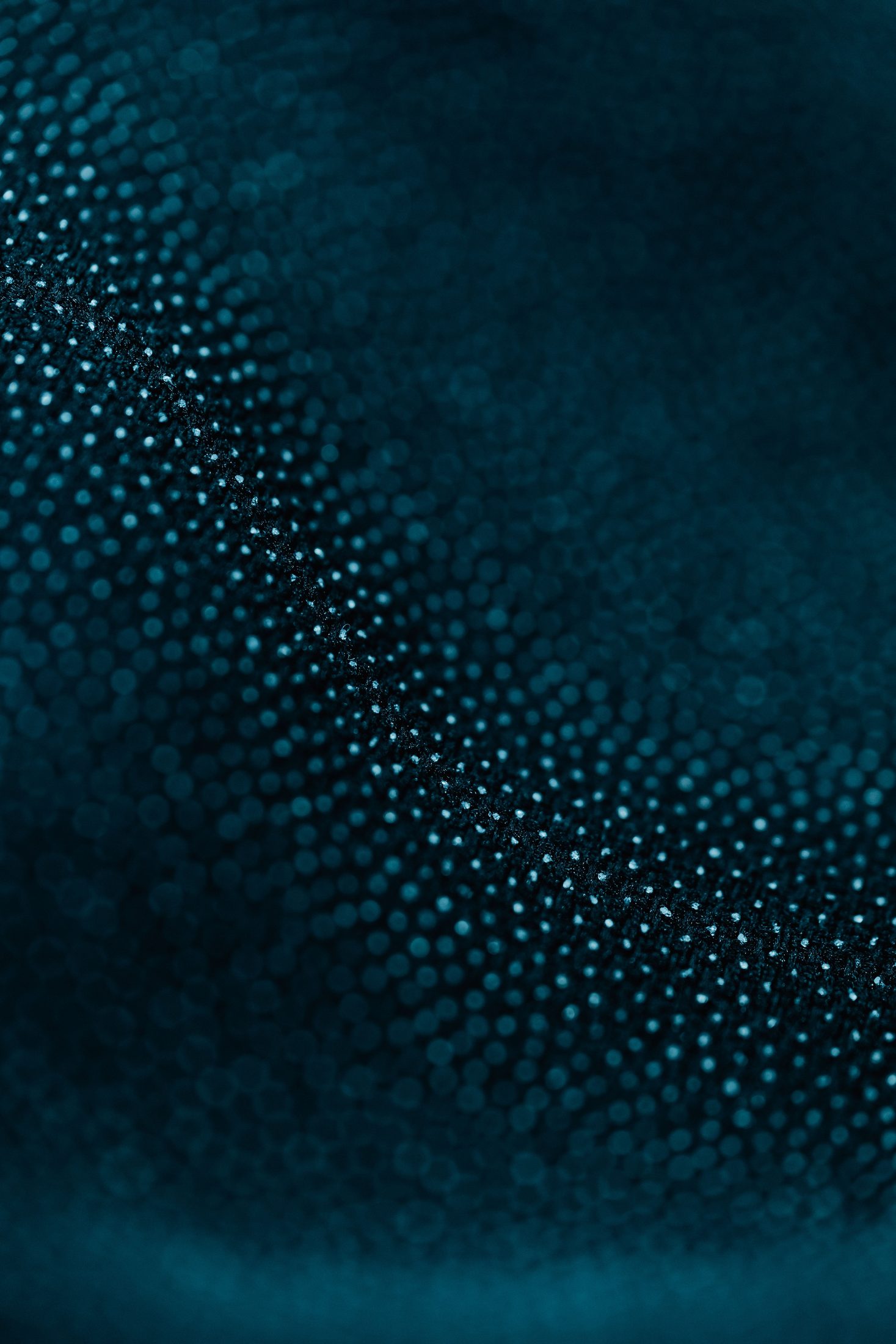 A dense pattern of blue dots fading into dark.